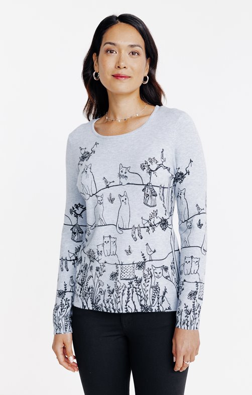 Pull imprimé chats dans un jardin